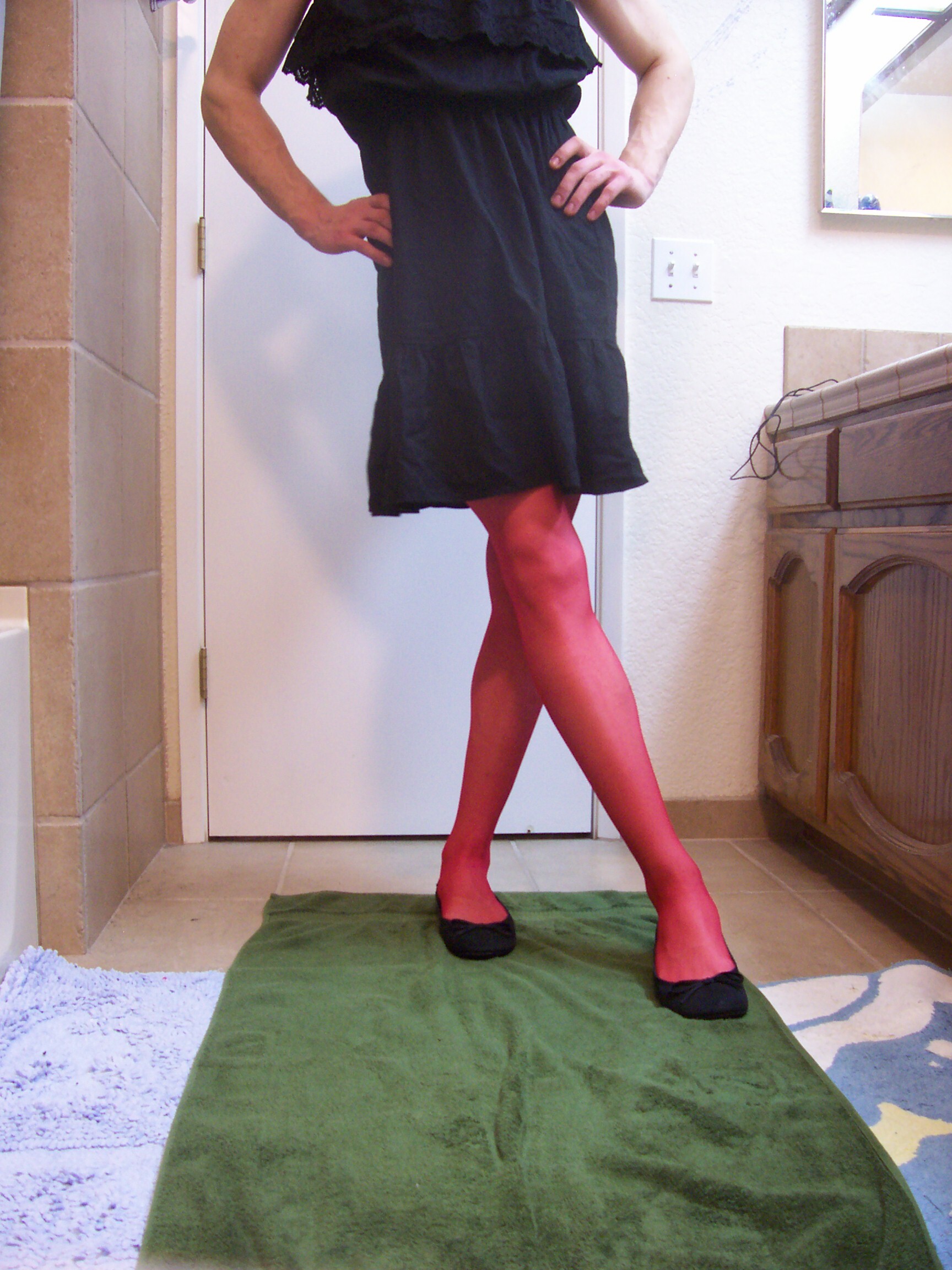 Crossdresser Samantha In A Black Dress With Red Garters Stockings