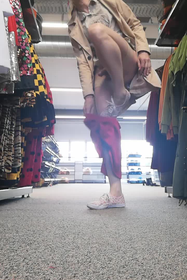 Bella flashing and playing in clothes store